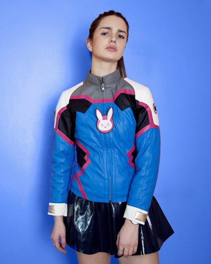 Person wearing a blue jacket with a rabbit emblem on a blue background