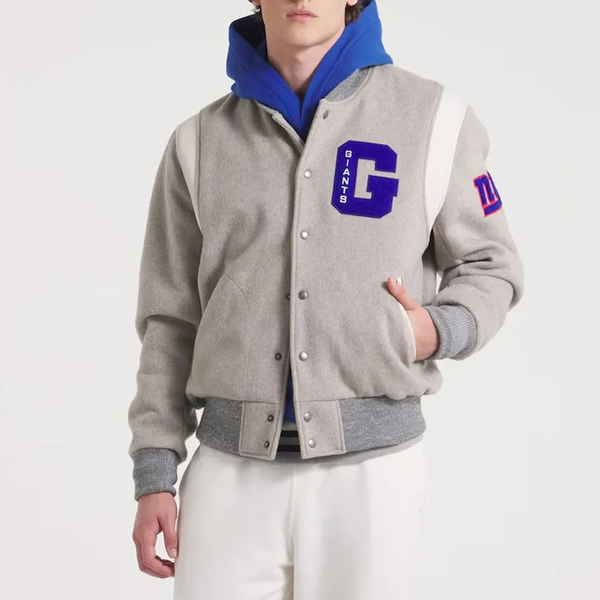 Person wearing a gray varsity jacket with blue hood and 'GIANTS' logo on a white background