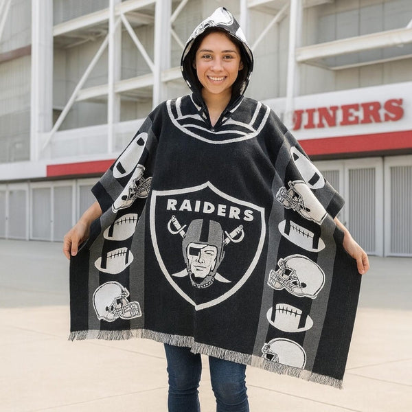 Person wearing a Raiders-themed poncho in front of a stadium.